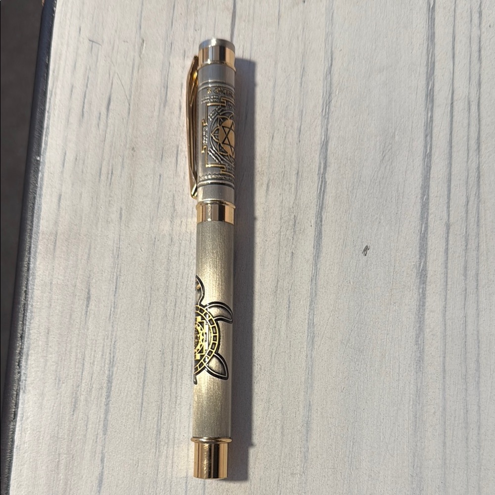 Elegant Silver and Gold Pen with Intricate Design